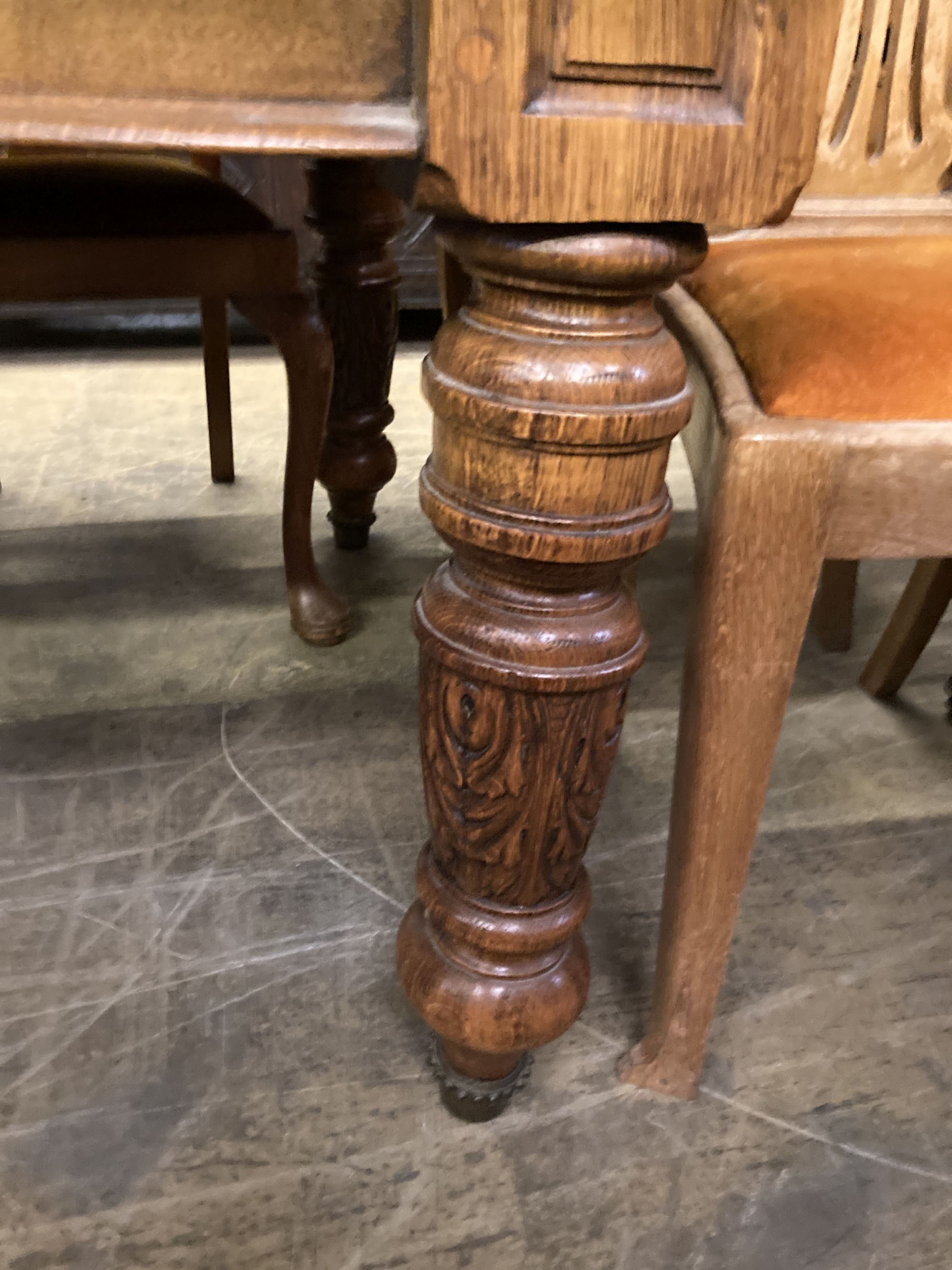 An early 20th century carved oak extending dining table, 294cm fully extended (three spare leaves), width 110cm, height 72cm